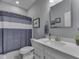 Bright bathroom featuring modern fixtures, a toilet with blue curtain, and ample natural light at 3697 Chalmers Dr, Bargersville, IN 46106