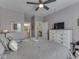 Comfortable bedroom with a fan, dresser, a TV, and decoratively adorned with wall art at 3697 Chalmers Dr, Bargersville, IN 46106