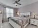 Cozy bedroom features a ceiling fan, natural light through the curtains, and a comfortable bed at 3697 Chalmers Dr, Bargersville, IN 46106