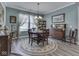 Bright dining room with charming décor, a round table set on an area rug, and ample natural light at 3697 Chalmers Dr, Bargersville, IN 46106