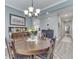 Well-lit dining room featuring classic furniture and hardwood flooring, creating a warm, inviting atmosphere at 3697 Chalmers Dr, Bargersville, IN 46106