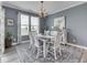 Elegant dining room with large window, stylish rug, and decorative lighting fixture at 3697 Chalmers Dr, Bargersville, IN 46106