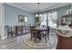 Elegant dining area featuring a round wooden table, decorative rug, and large windows for a bright, inviting space at 3697 Chalmers Dr, Bargersville, IN 46106