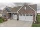 Attractive single-story home with brick facade, complemented by a well-kept lawn and a spacious two-car garage at 3697 Chalmers Dr, Bargersville, IN 46106