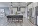 Spacious kitchen with modern appliances, island seating, and view to the dining room at 3697 Chalmers Dr, Bargersville, IN 46106