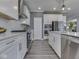 Well-equipped kitchen with stainless steel appliances, ample counter space, and stylish white cabinets at 3697 Chalmers Dr, Bargersville, IN 46106