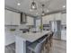 Modern kitchen with stainless steel appliances, island seating, and ample countertop space at 3697 Chalmers Dr, Bargersville, IN 46106