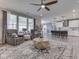 Spacious living room with ceiling fan, stylish rug, hardwood floors, and open view into a kitchen at 3697 Chalmers Dr, Bargersville, IN 46106