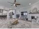 Inviting living room featuring a fireplace, large rug, ceiling fan, and an open view to the kitchen at 3697 Chalmers Dr, Bargersville, IN 46106