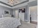 Spacious main bedroom features a tray ceiling, ceiling fan, and white dressers for ample storage at 3697 Chalmers Dr, Bargersville, IN 46106