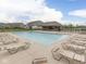 Community pool featuring ample lounge seating and a pool house in a serene environment at 3697 Chalmers Dr, Bargersville, IN 46106
