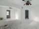 Spacious living room awaiting renovation, featuring archways, vintage ceiling fans, and ample natural light at 3706 Baltimore Ave, Indianapolis, IN 46218