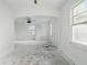 Renovation opportunity: living area with original flooring, freshly painted white walls, and an open floorplan at 3706 Baltimore Ave, Indianapolis, IN 46218