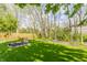 Large grassy backyard featuring mature trees, well maintained lawn and a wood fence at 3808 Brigade Cir, Carmel, IN 46032