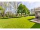 Large grassy backyard featuring mature trees, well maintained lawn and a wooden deck at 3808 Brigade Cir, Carmel, IN 46032
