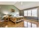 Cozy bedroom with vaulted ceiling, wooden bedframe, and natural light from a large window at 3808 Brigade Cir, Carmel, IN 46032