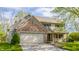 Charming two-story home featuring a brick facade, attached garage, and lush green lawn at 3808 Brigade Cir, Carmel, IN 46032