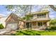 Inviting two-story home featuring a covered porch, brick accents, and well-manicured landscaping at 3808 Brigade Cir, Carmel, IN 46032
