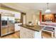 Modern kitchen with stainless steel refrigerator, center island, and open layout to the dining area at 3808 Brigade Cir, Carmel, IN 46032