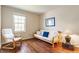 Living Room with Hardwood Floors, White Sofa and Chair, and a Large Window with Natural Light at 3808 Brigade Cir, Carmel, IN 46032