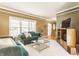 Bright living room with a large window, plush seating, and elegant crown molding at 3808 Brigade Cir, Carmel, IN 46032