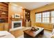 Inviting living room with a fireplace and charming built-in shelving for storage and display at 3808 Brigade Cir, Carmel, IN 46032