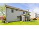 Back of home featuring an enclosed porch, neutral siding, and a well-maintained lawn under a partly cloudy sky at 3808 Brigade Cir, Carmel, IN 46032