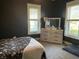 This bedroom offers neutral carpet, bright natural light, and plenty of dresser storage at 40 N Park Ave, Martinsville, IN 46151