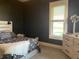 Inviting bedroom with dark walls, wood-look accents and natural light from the window, offering a cozy retreat at 40 N Park Ave, Martinsville, IN 46151