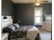 This comfortable bedroom features neutral tones, a ceiling fan, and a bright window for a relaxing atmosphere at 40 N Park Ave, Martinsville, IN 46151