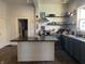 Open-concept kitchen with center island, modern appliances, and convenient open shelving at 40 N Park Ave, Martinsville, IN 46151