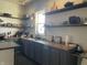 Well-organized kitchen featuring open shelving, gray cabinets, and plenty of counter space at 40 N Park Ave, Martinsville, IN 46151