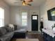 Cozy living room with gray sectional sofa, ceiling fan, and ample natural light at 40 N Park Ave, Martinsville, IN 46151