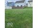 This backyard features a grassy area and a wooden fence at 4070 Presidio Cir, Indianapolis, IN 46235