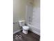 This bathroom features a tub/shower combo, toilet, and wood-look flooring at 4070 Presidio Cir, Indianapolis, IN 46235