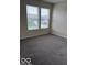 This carpeted bedroom features two bright windows and neutral wall color at 4070 Presidio Cir, Indianapolis, IN 46235