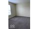 This carpeted bedroom offers neutral walls and ample natural light at 4070 Presidio Cir, Indianapolis, IN 46235