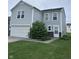 Charming two-story home with light gray siding, a white garage door, and manicured lawn at 4070 Presidio Cir, Indianapolis, IN 46235