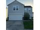 Two-story home featuring an attached garage, well-kept lawn, and stone facade accents at 4070 Presidio Cir, Indianapolis, IN 46235