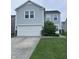 Charming two-story home with light gray siding, a white garage door, and manicured lawn at 4070 Presidio Cir, Indianapolis, IN 46235