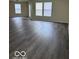 Spacious living room with new hardwood flooring, neutral paint, and large windows at 4070 Presidio Cir, Indianapolis, IN 46235