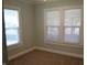 A cozy bedroom with fresh paint and two windows provide lots of natural light at 4736 Madison Ave, Indianapolis, IN 46227