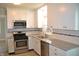 This kitchen features granite countertops, stainless steel appliances and ample cabinet space at 4736 Madison Ave, Indianapolis, IN 46227