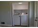 A laundry area features a modern washer and dryer with a shelf, tucked neatly into a closet space at 4736 Madison Ave, Indianapolis, IN 46227