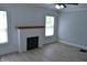 Bright living room features a decorative fireplace, new light fixture and light and airy paint at 4736 Madison Ave, Indianapolis, IN 46227
