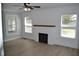 Spacious living room features a decorative fireplace, and three large windows that offer plenty of natural light at 4736 Madison Ave, Indianapolis, IN 46227