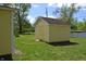 Exterior view of storage shed with a brown roof and yellow siding at 4736 Madison Ave, Indianapolis, IN 46227