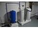 Basement utilities include a water softener, water heater, and blue pressure tank on a white brick wall at 4736 Madison Ave, Indianapolis, IN 46227