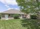 Green backyard featuring a brick house, wooden patio, and an expanse of lush lawn at 4759 Silver Hill Dr, Greenwood, IN 46142