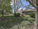 Backyard featuring a patio area and well-maintained lawn surrounded by mature trees at 4759 Silver Hill Dr, Greenwood, IN 46142